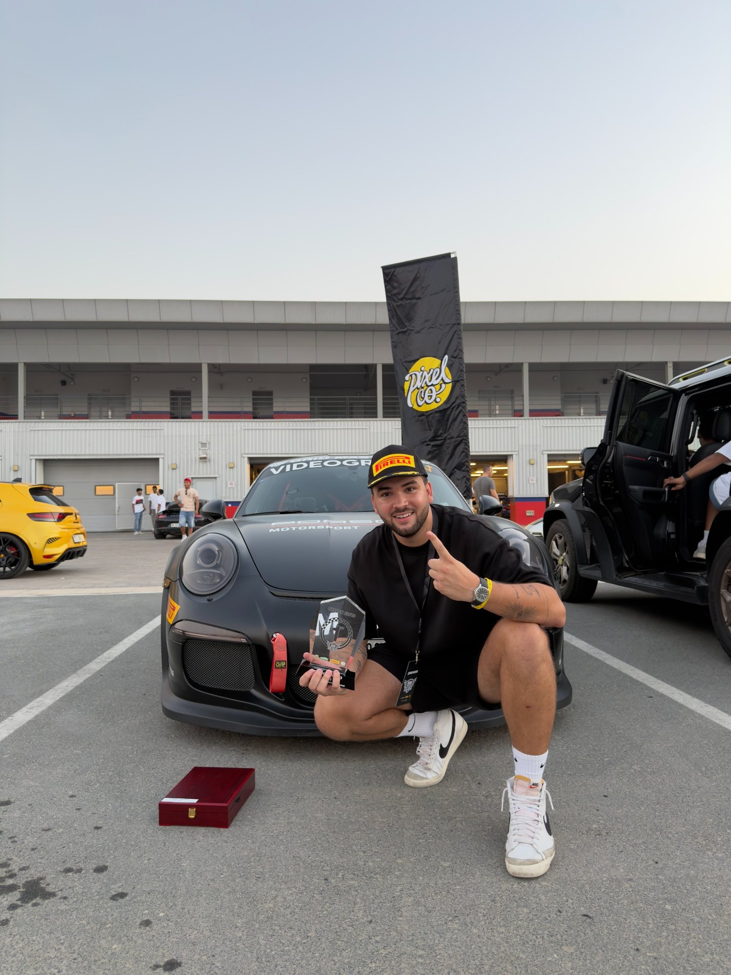 Elliott with the trophy in front of the car